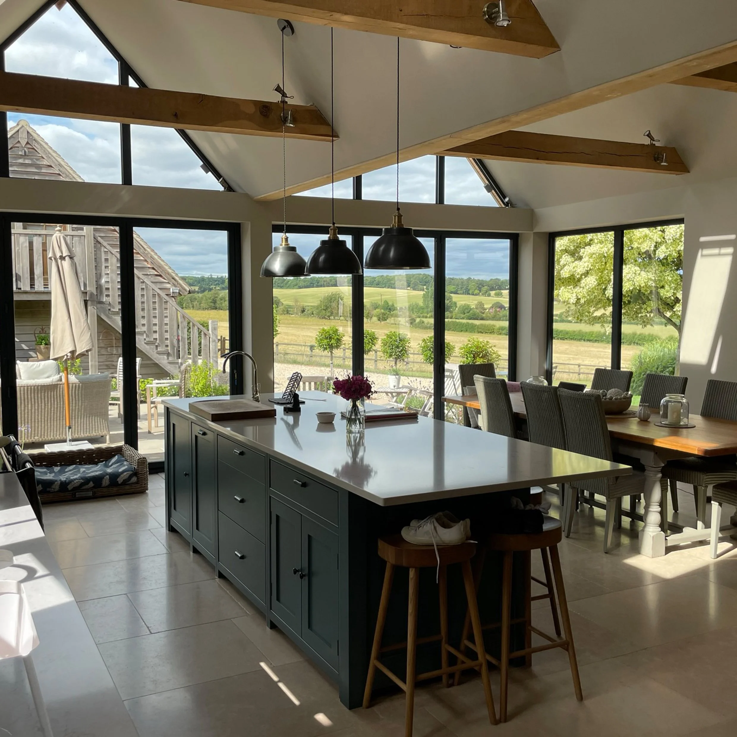 The Modern dual-gable glazed ground floor extension to a 17th century house introduces a new kitchen/dining space to this family home.