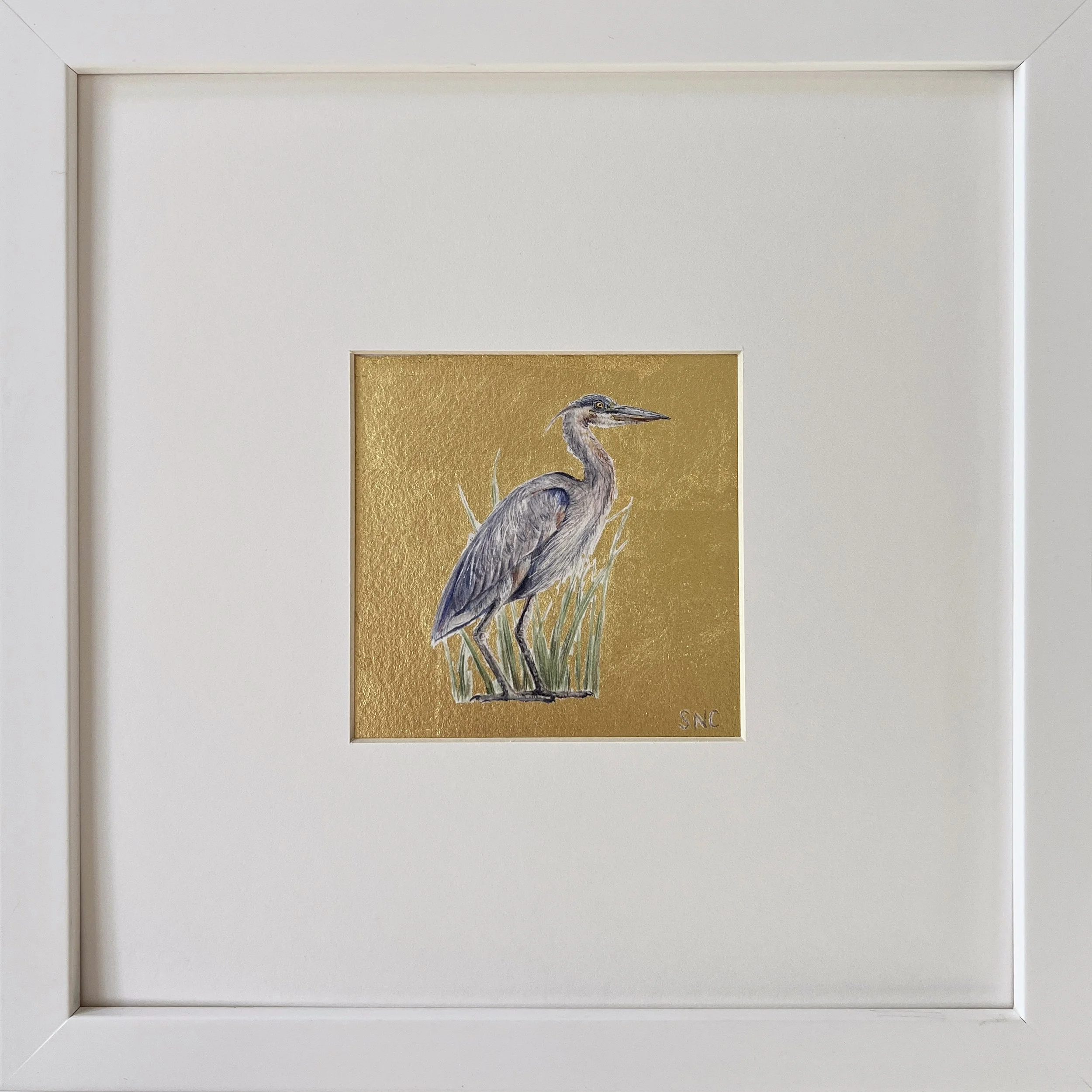 Blue Heron Gem. Watercolor and 22 karat gold. Matted and framed in a white gallery frame. 10x10 inches.