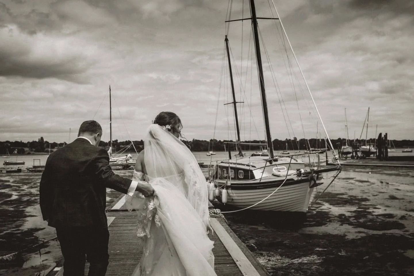 S &amp; J taking their first stroll outside the iconic Butt &amp; Oyster pub after their barn ceremony at the beautiful Tithe Barn in Suffolk.⁠
⁠Of course, we paused for a quick pint to soak it all in &mdash; I just love a relaxed wedding day like th