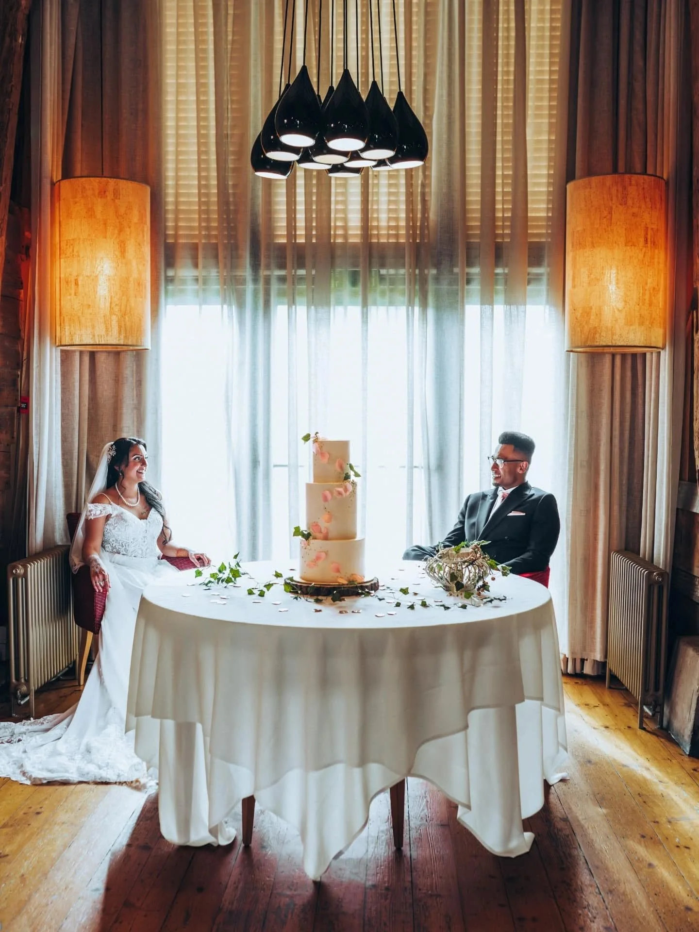 Love, love, love how Firdos and Miles are stealing a quiet glance at that dreamy cake &mdash; just before Firdos slipped into her second dress and they each enjoyed a big, delicious slice. Captured at the stunning Barn Brasserie in Great Tey near Col