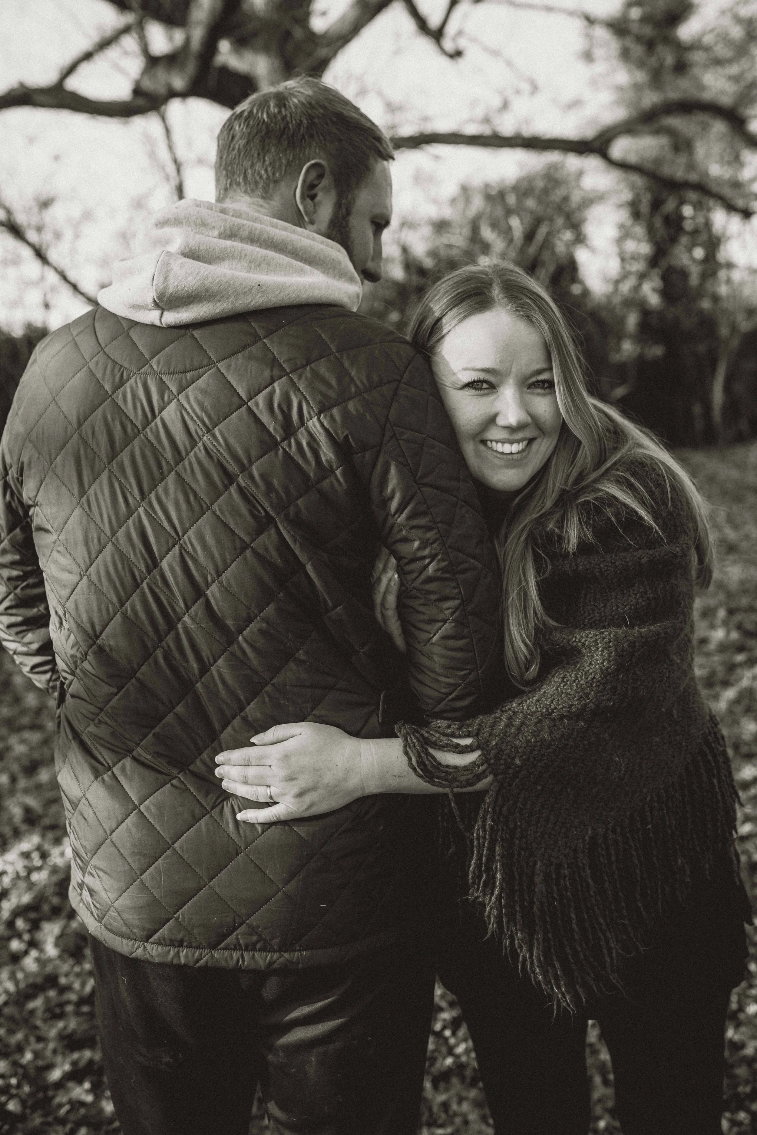 A couple playfully hugging during an engagement session near Colchester