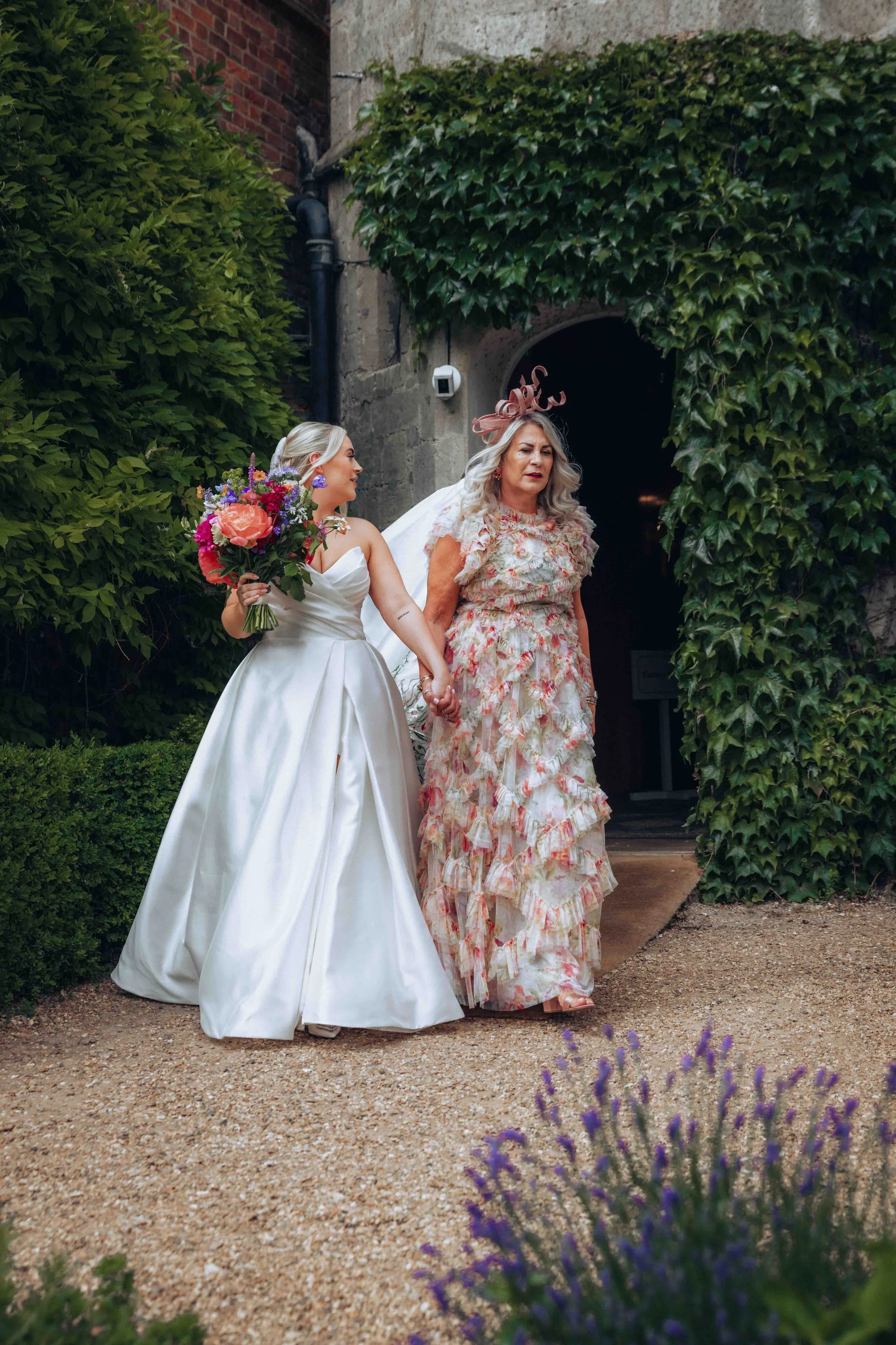 Bride and mother of the bride are leaving for summer outdoor ceremony at Hockwold Hall in Hockwold cum Wilton