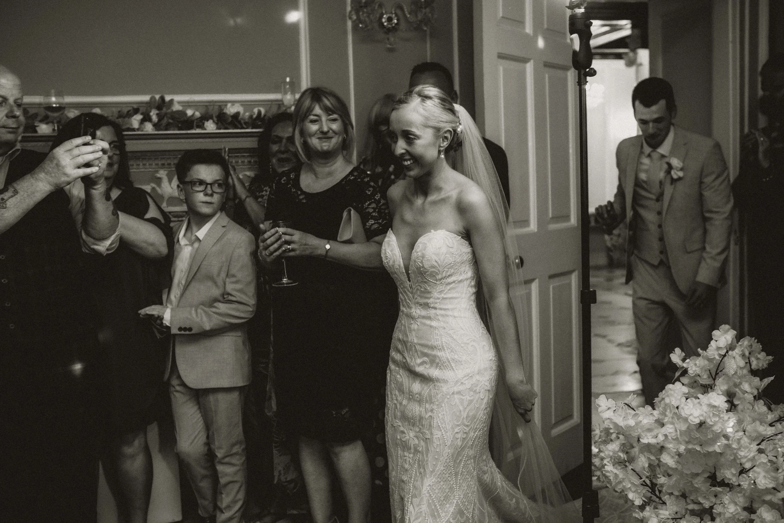 A bride and groom entering the dance floor for their first dance at Hutton Hall in Brentwood
