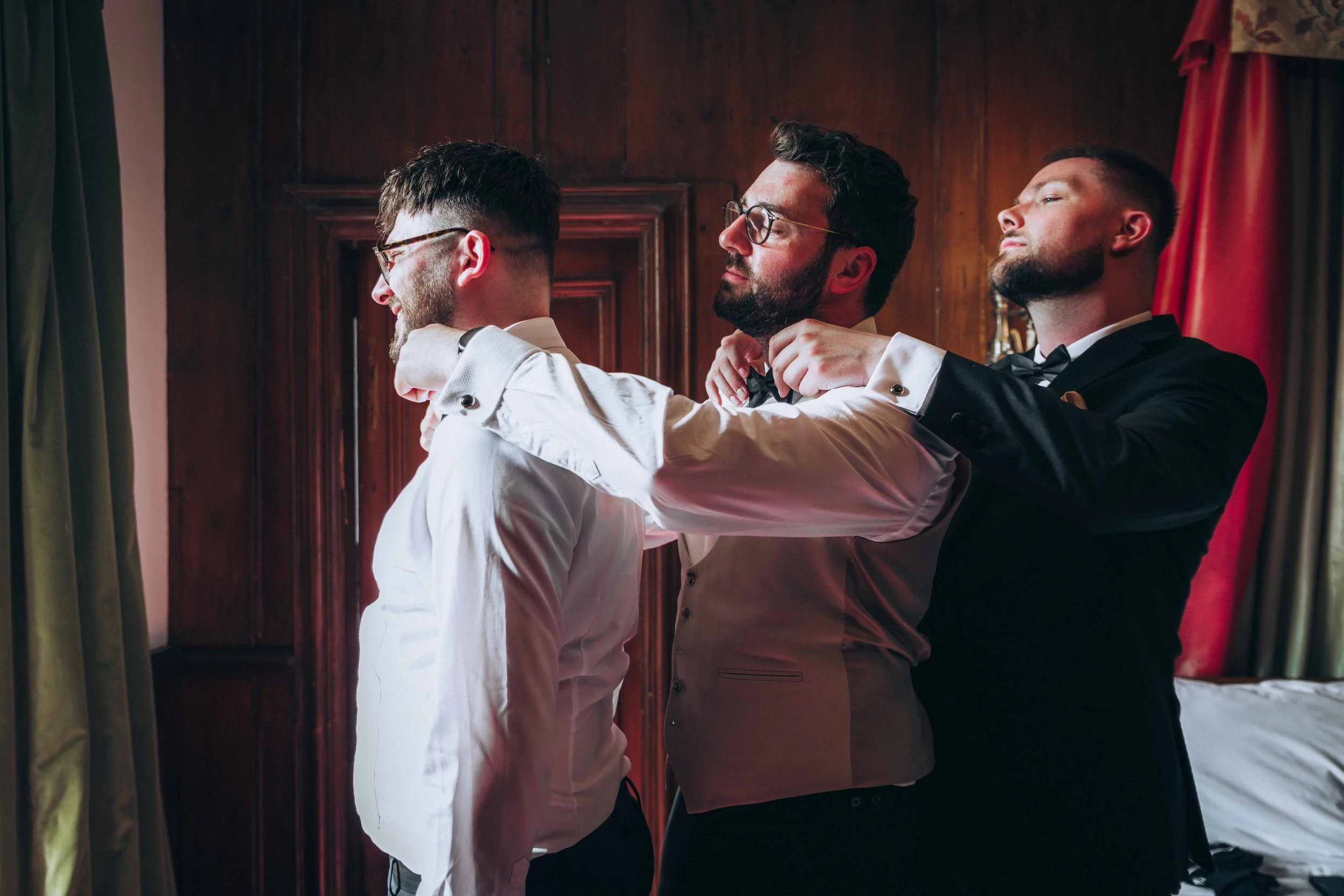 Groom and his groomsmen standing in a row getting ready at Hockwold Hall in Brandon Norfolk