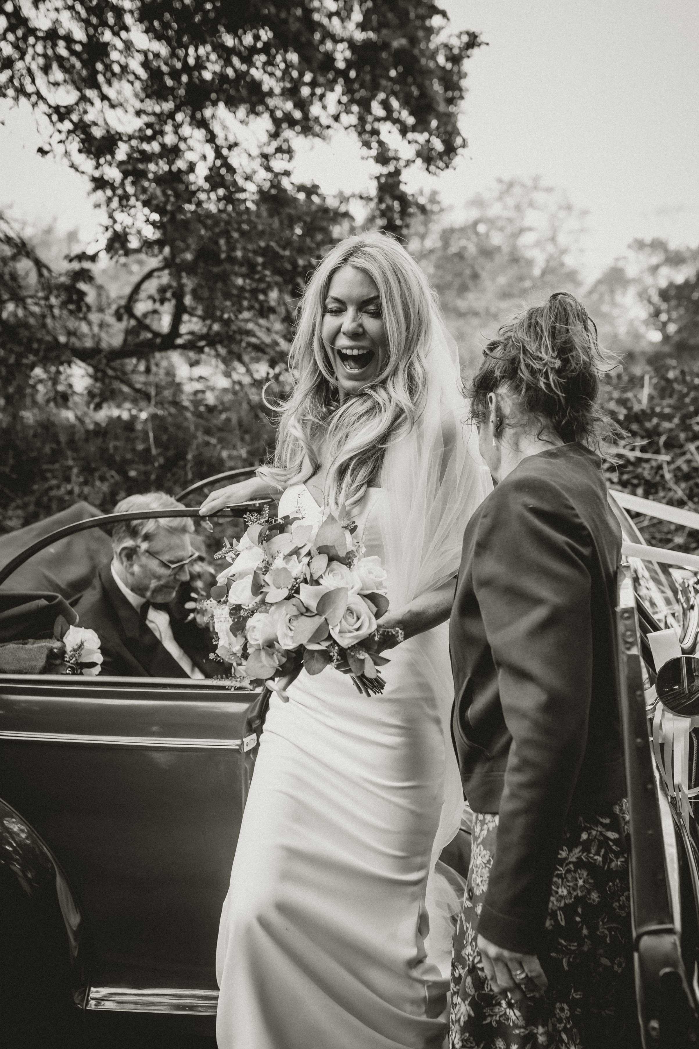 Bride leaving the car before the chuch ceremony in Norfolk, Norfolk wedding photographer