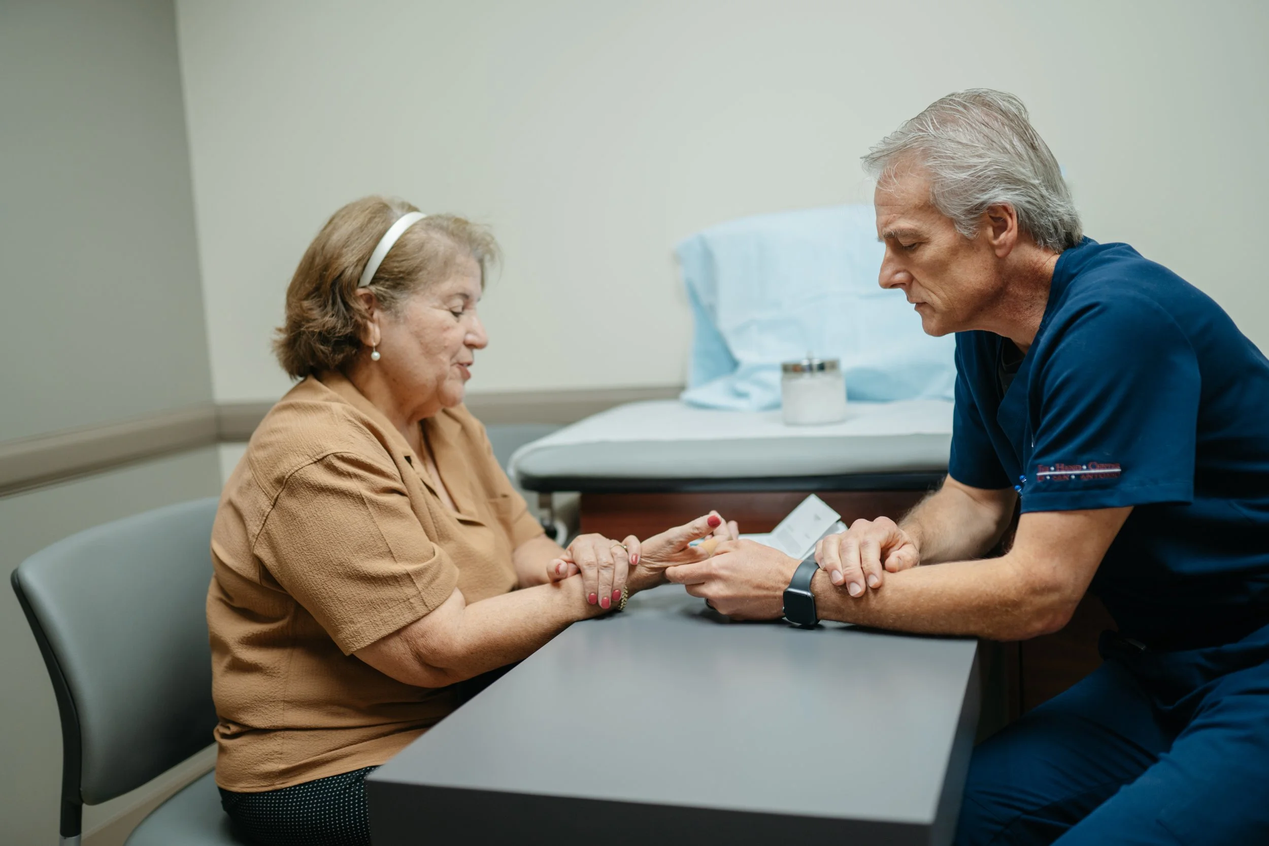 Hand specialist at The Hand & Upper Extremity Center of San Antonio, texas evaluating a patient with sudden wrist pain