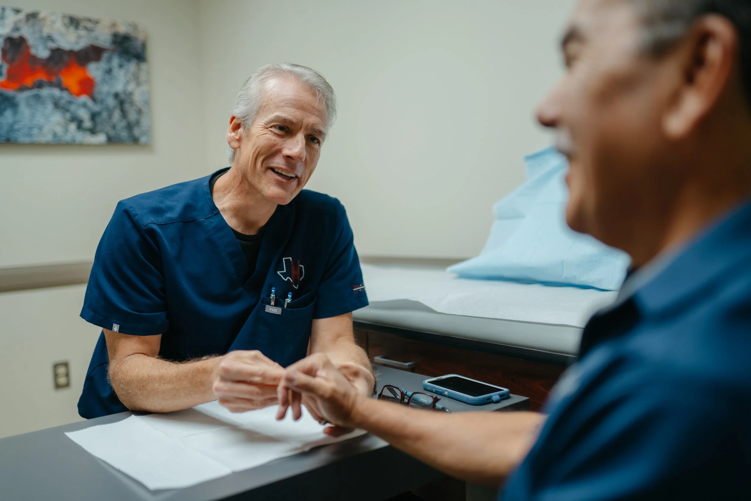 Hand Center San Antonio exam room with patient consultation