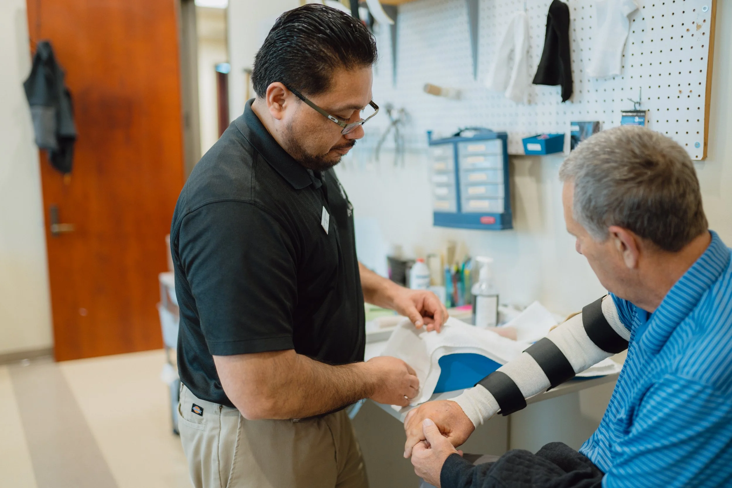Hand specialist evaluating elbow pain patient at The Hand & Upper Extremity Center of San Antonio in San Antonio, Texas
