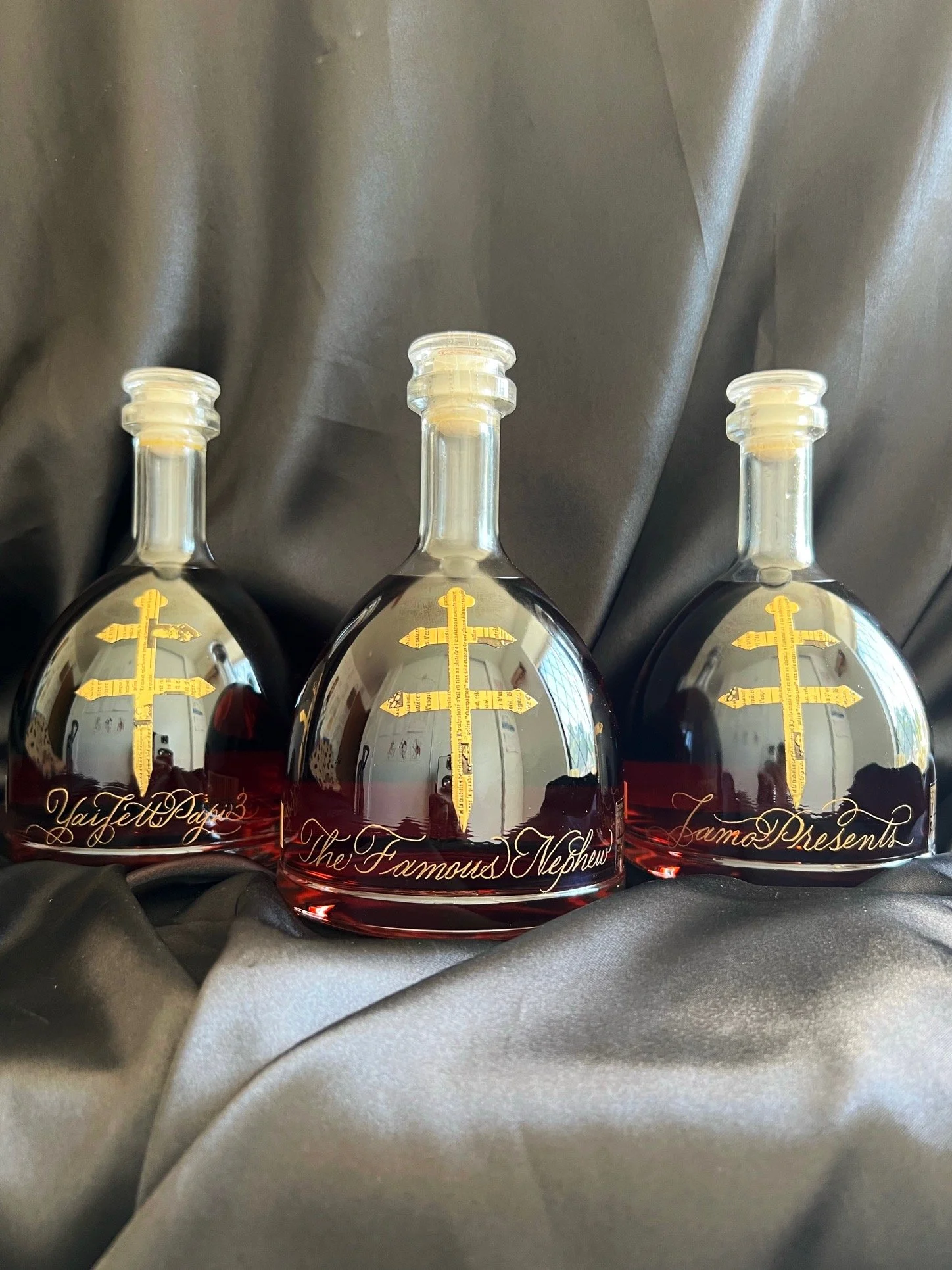 Hand engraved names and phrases in gold on Dusse cognac bottles
