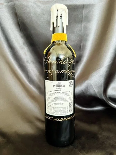 Hand engraved gratitude note in gold on wine bottle
