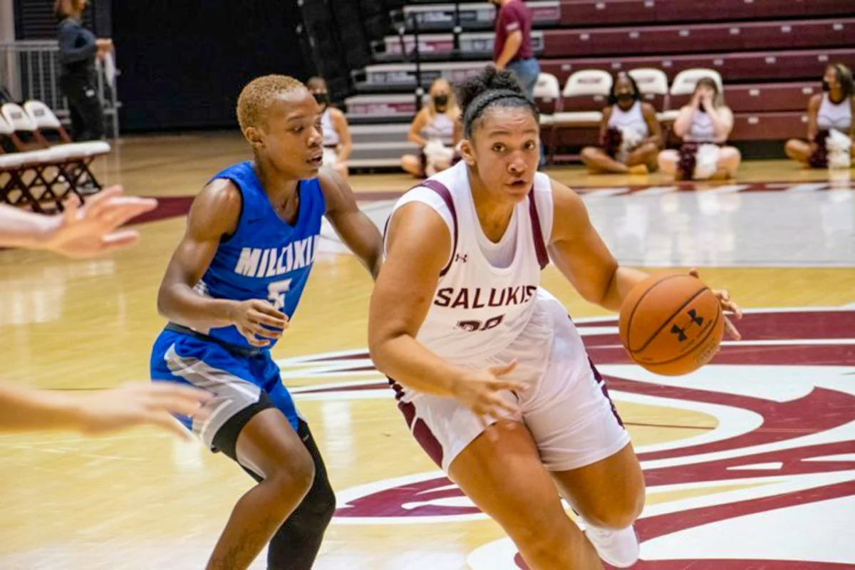 SIU Women's Basketball graduate student forward Gabby Walker (20) evades Millikin senior guard Jazmin Brown (5) for a basket during an exhibition match on Oct. 31, 2021 at Banterra Center in Carbondale, Illinois. (Jason Isele/SIU Athletics Freelance)