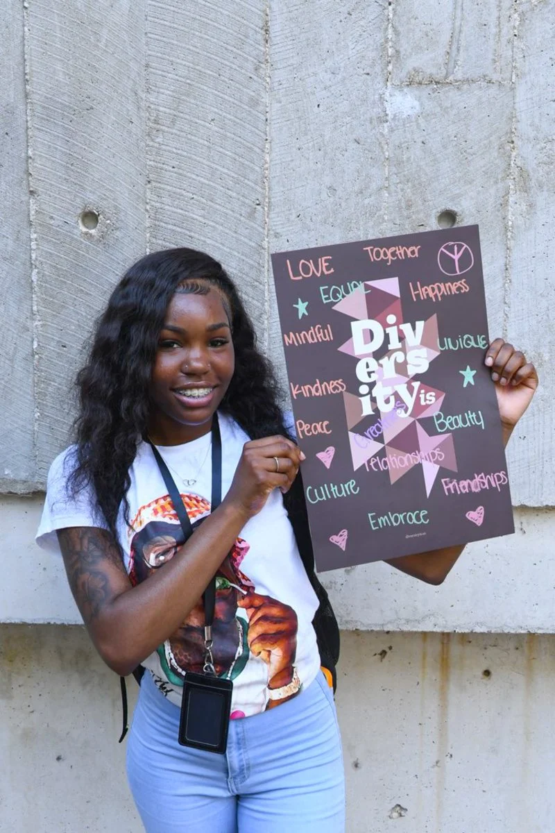 Freshman Tatiana Scales stands for a portrait with her “Diversity Is” poster Aug. 29, 2024 at the SIU Faner Breezeway in Carbondale, Illinois. (Jason Isele/The Daily Egyptian)