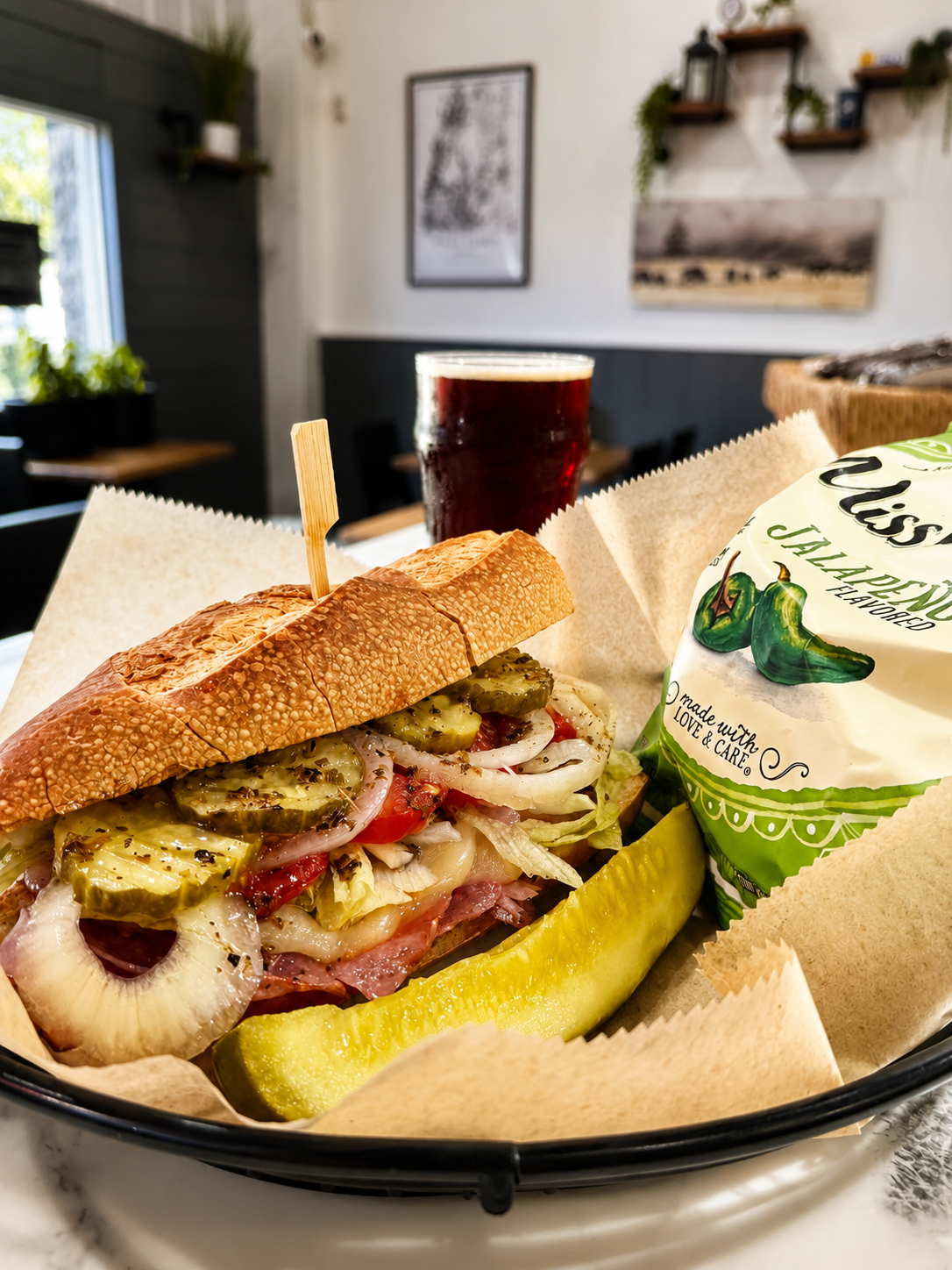 Signature Italian sandwich, kettle chips, pickle, and craft beer at Thirsty Buffalo Brewing Company in Odessa, Florida