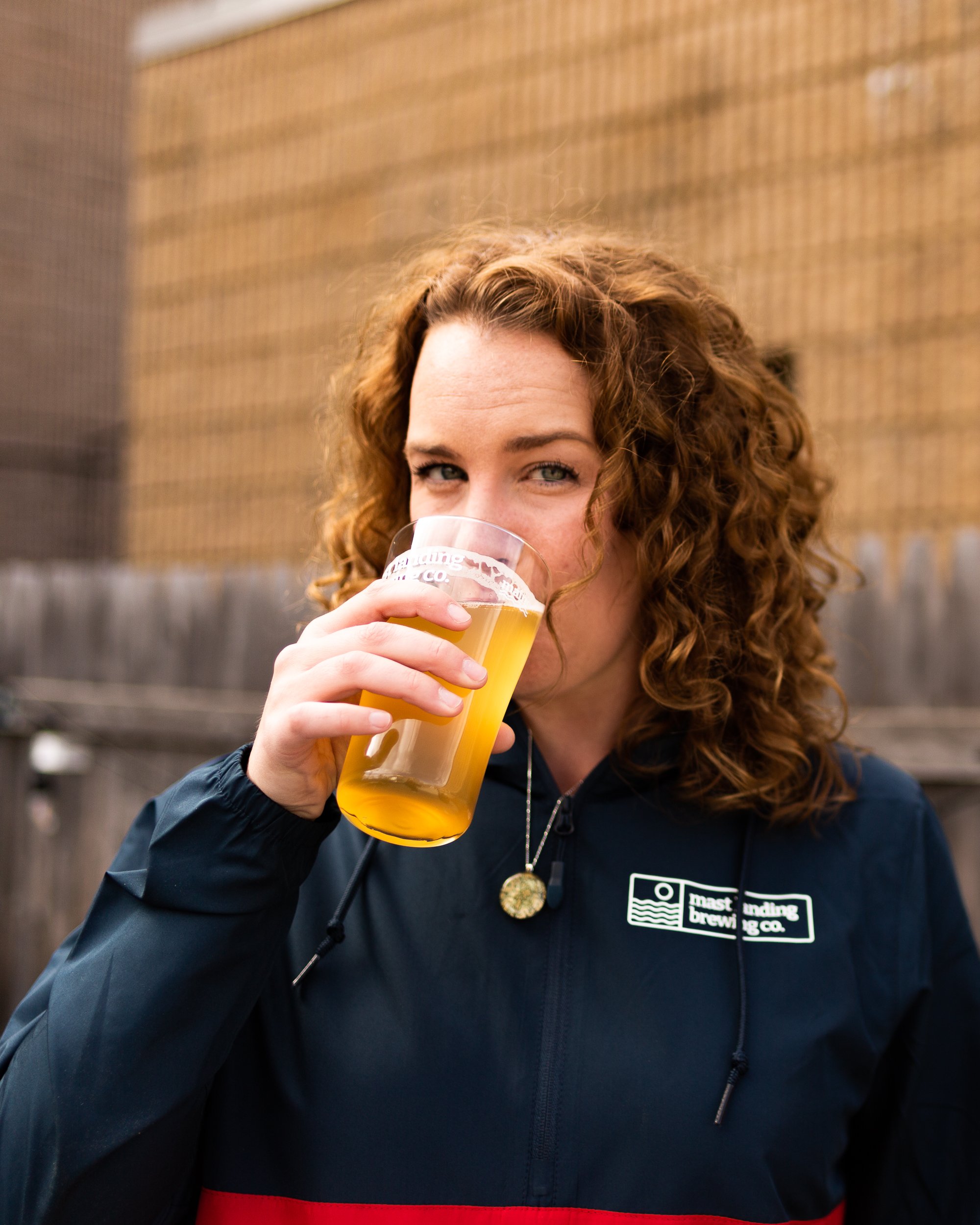  a woman sips a beer 