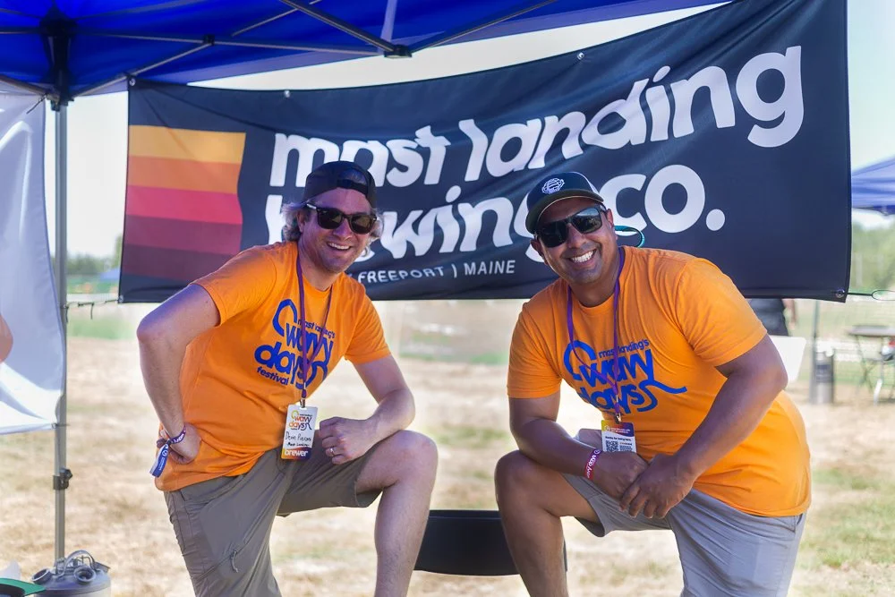 two men pour beers at a tent