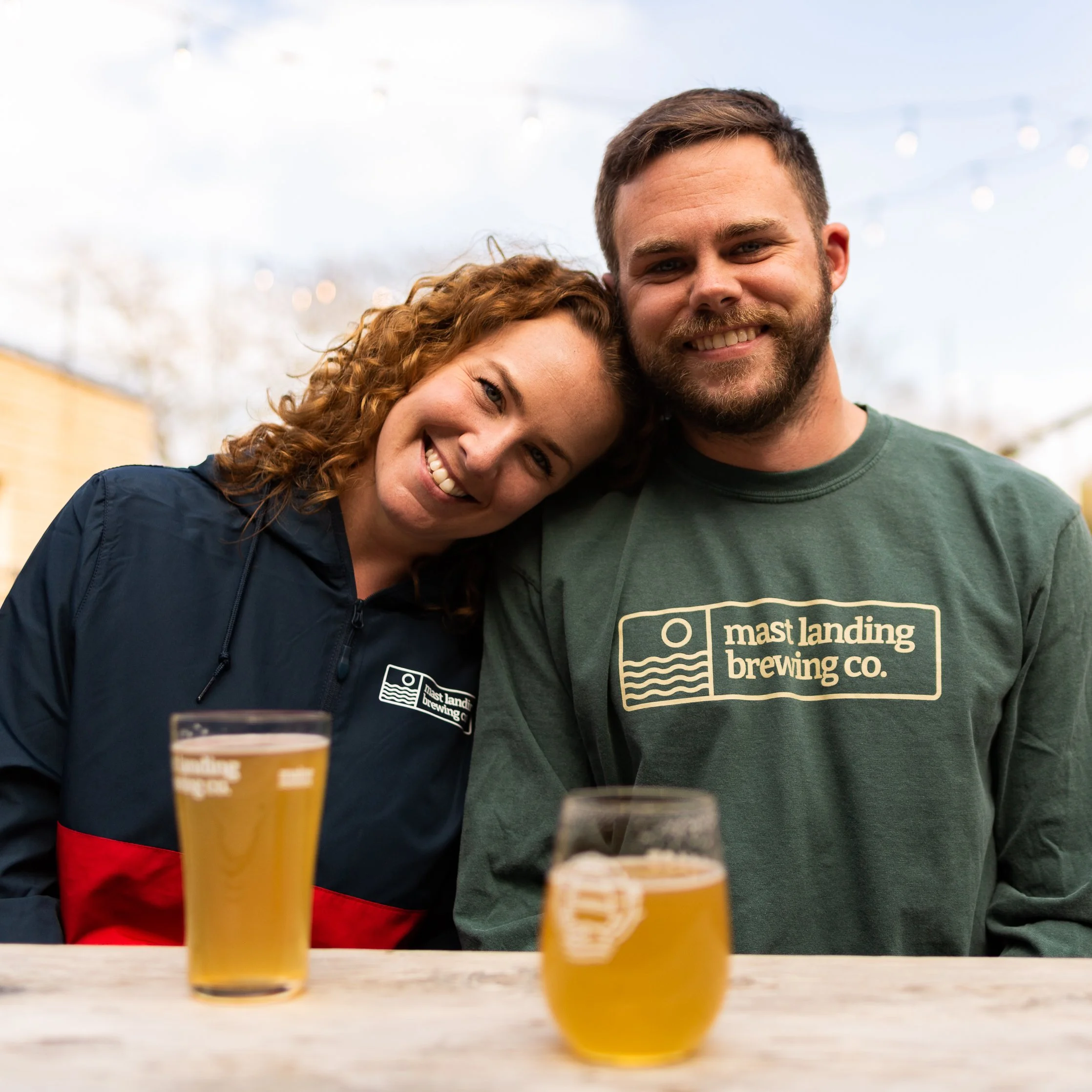 two people enjoy a beer at mast landing