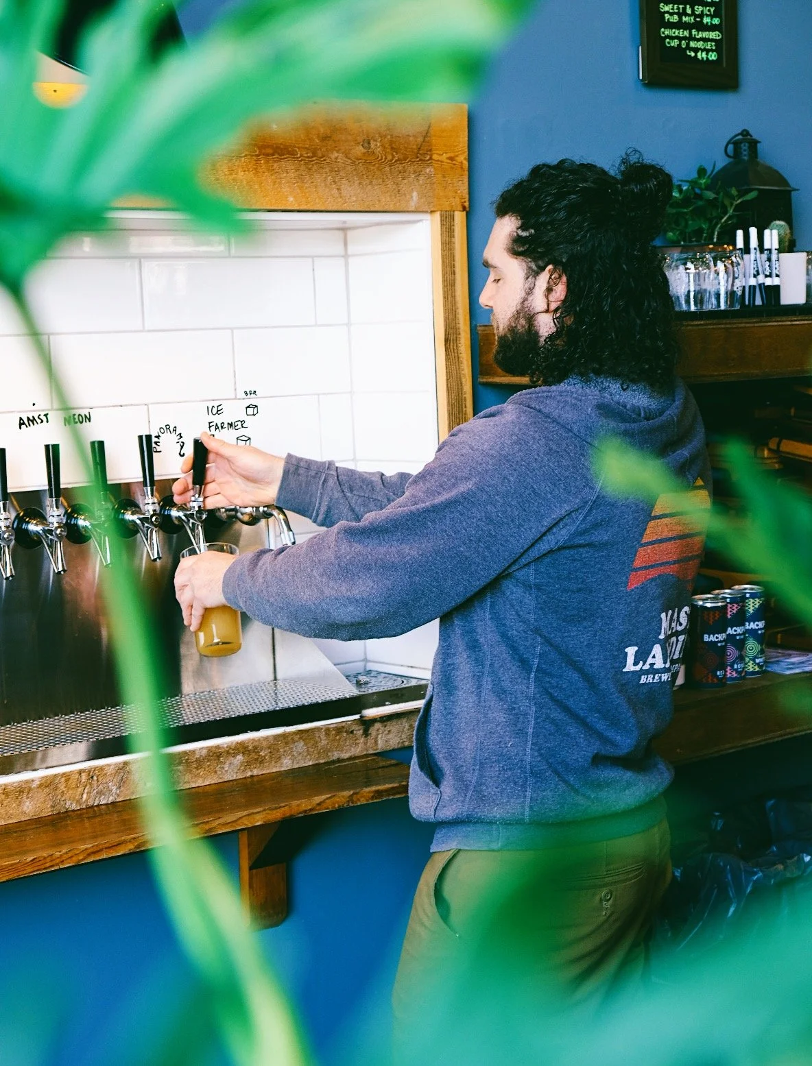 mast landing employee pours beer