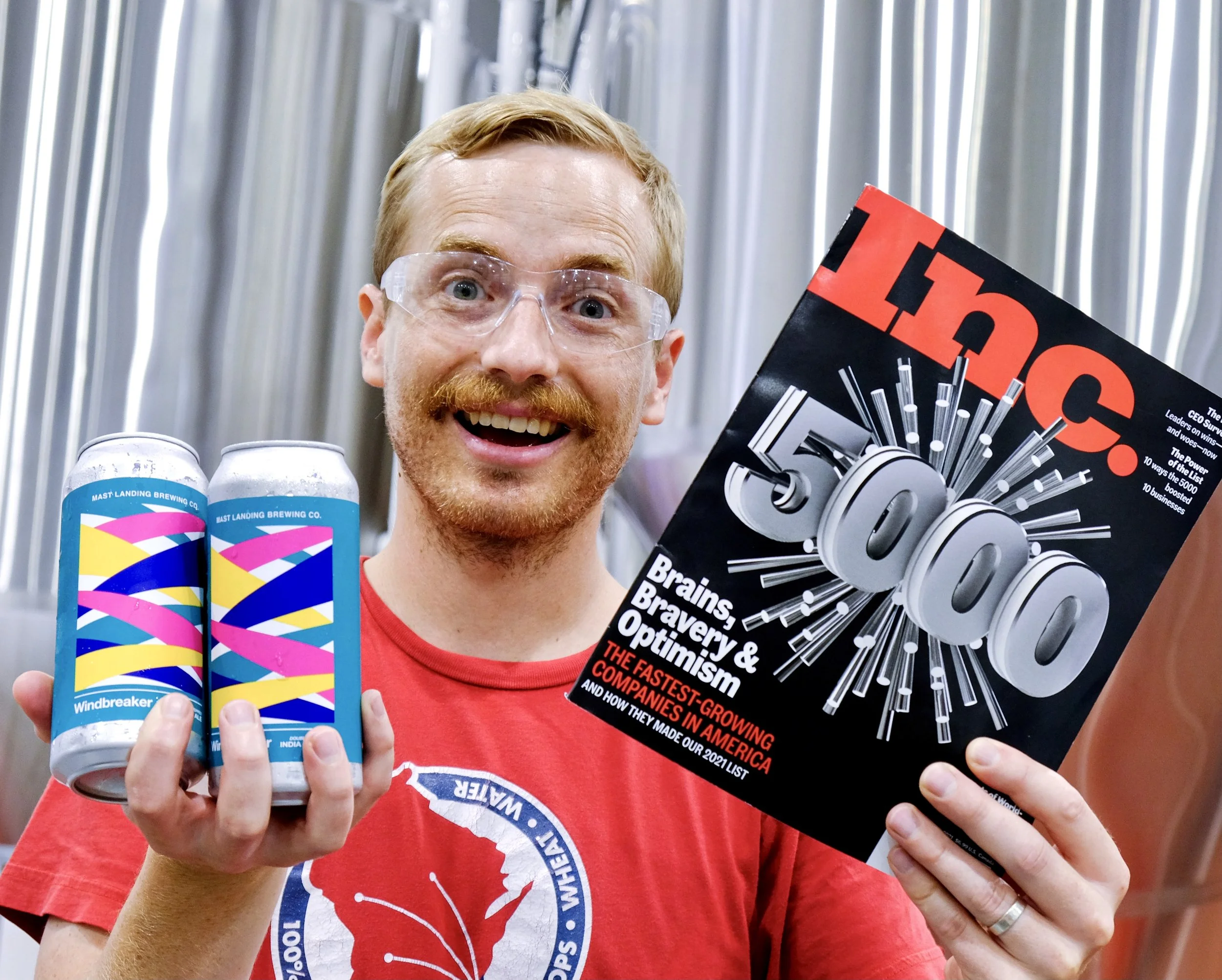 mast landing employee holds Inc. 5000 and beer