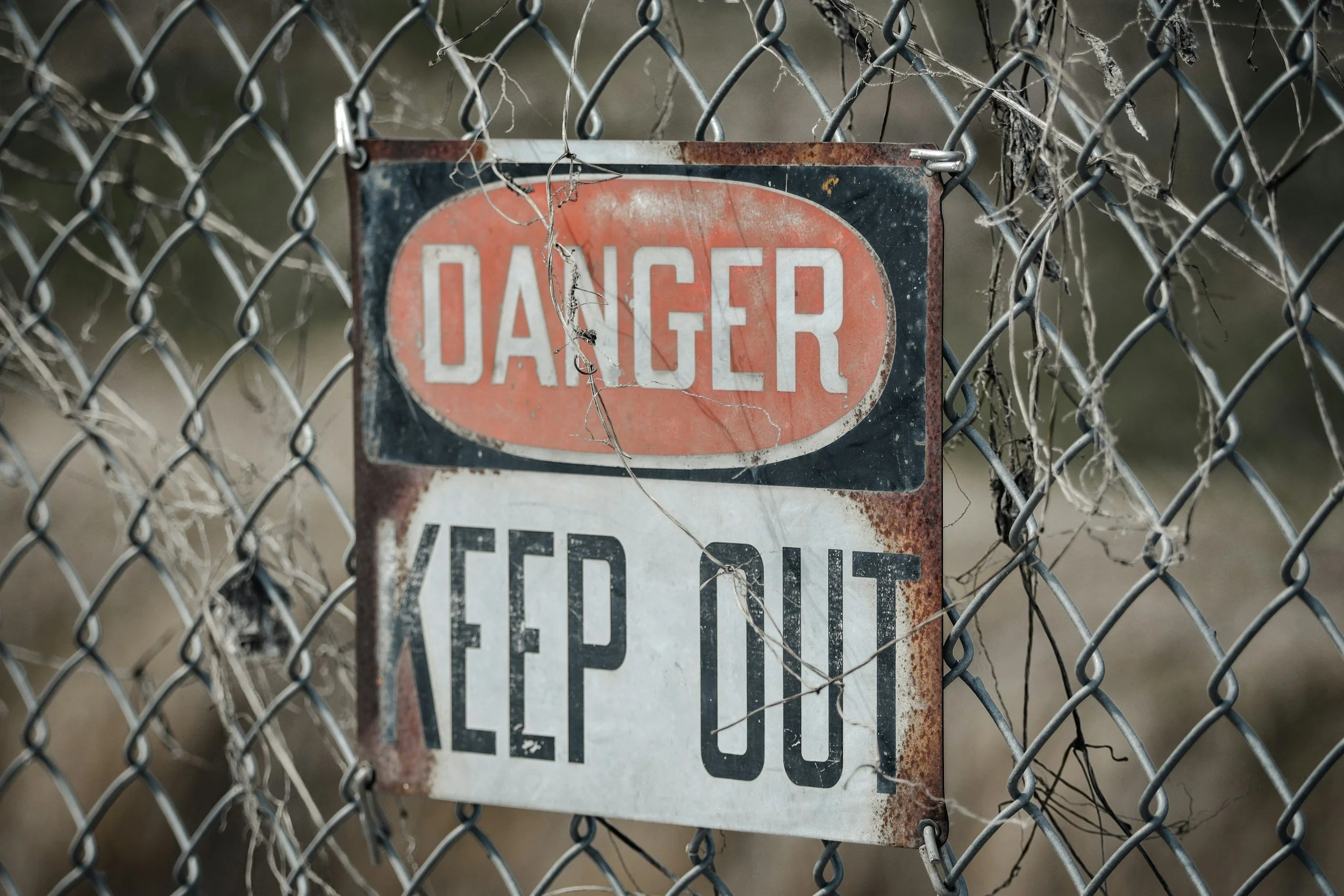 sign that reads 'danger keep out' on a fence representing your nervous system