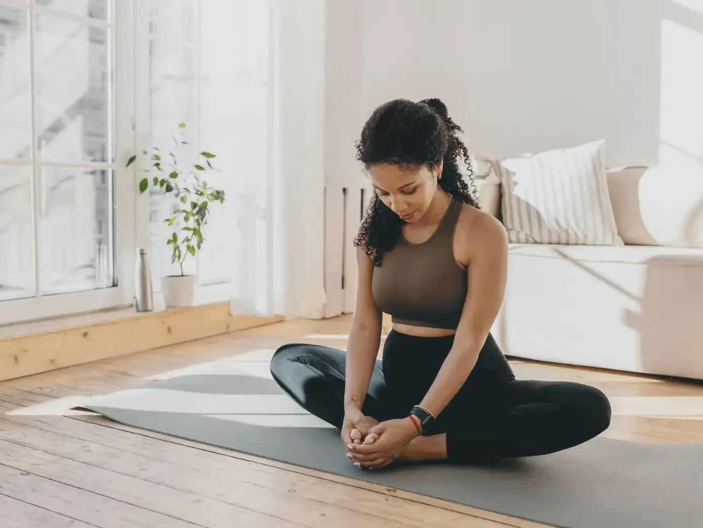 Woman sitting on floor in yoga pose