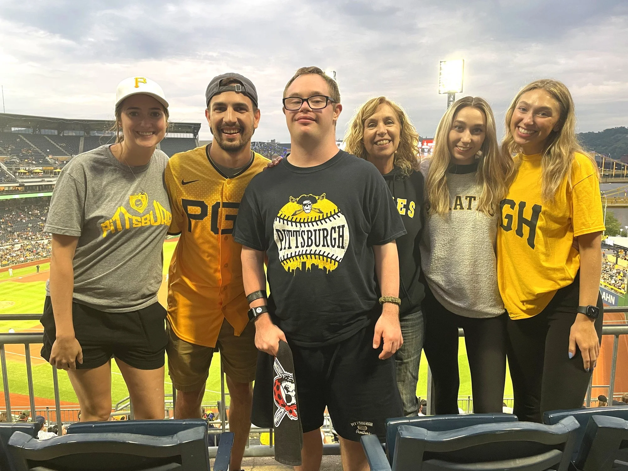 A group enjoying a Pittsburgh Pirates game at dusk