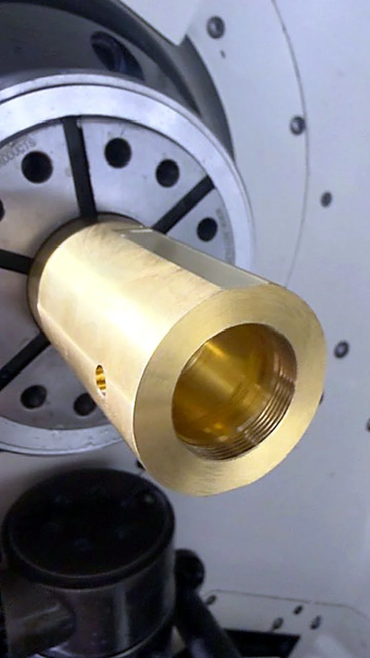 Brass bushing in a CNC lathe chuck