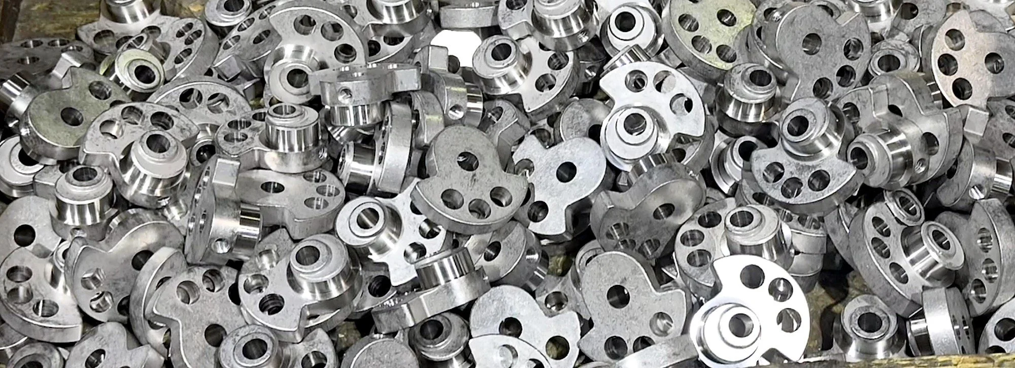Bin of machined aluminum production parts at PBI