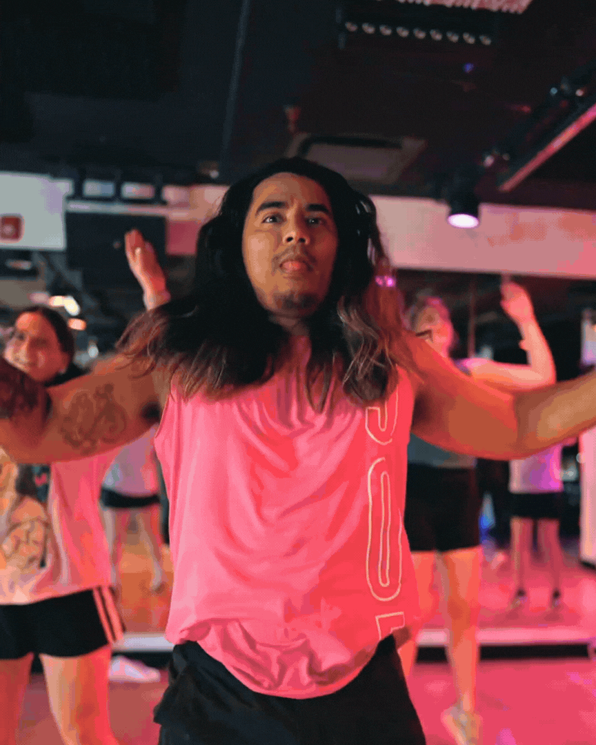 305 Fitness class footage shows people smiling, clapping, and laughing while dancing and exercising in athletic clothes