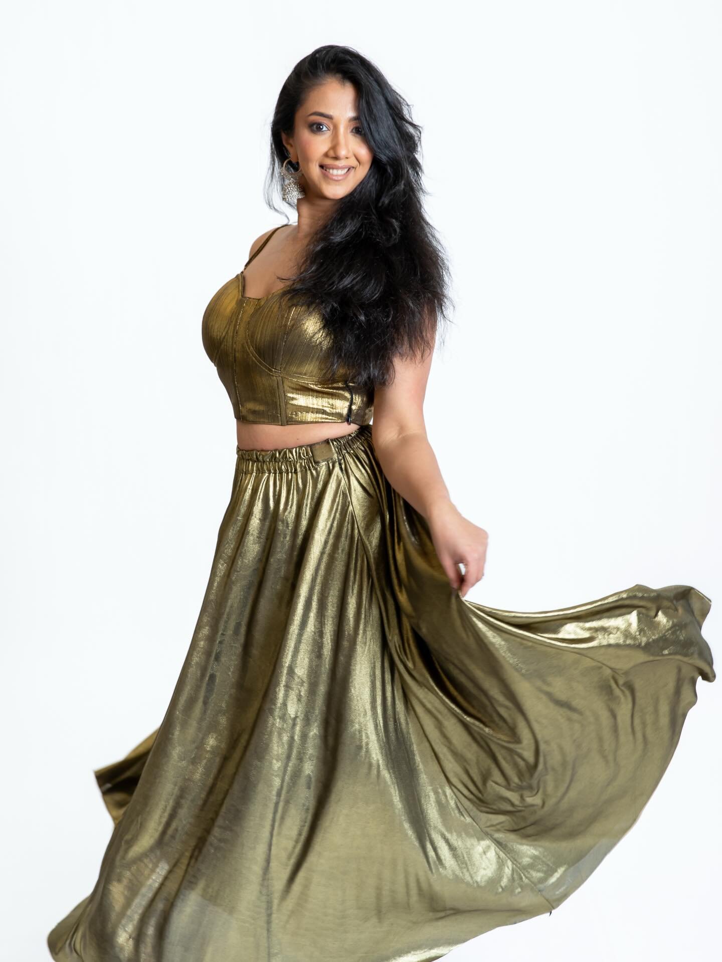 Golden hour, but make it dance floor ready ✨
The Afreen Set brings all the drama &mdash; a sculpted metallic top paired with a flowy skirt that moves with every twirl, step, and spin. Made to shimmer, made to move, and definitely made to steal the sp