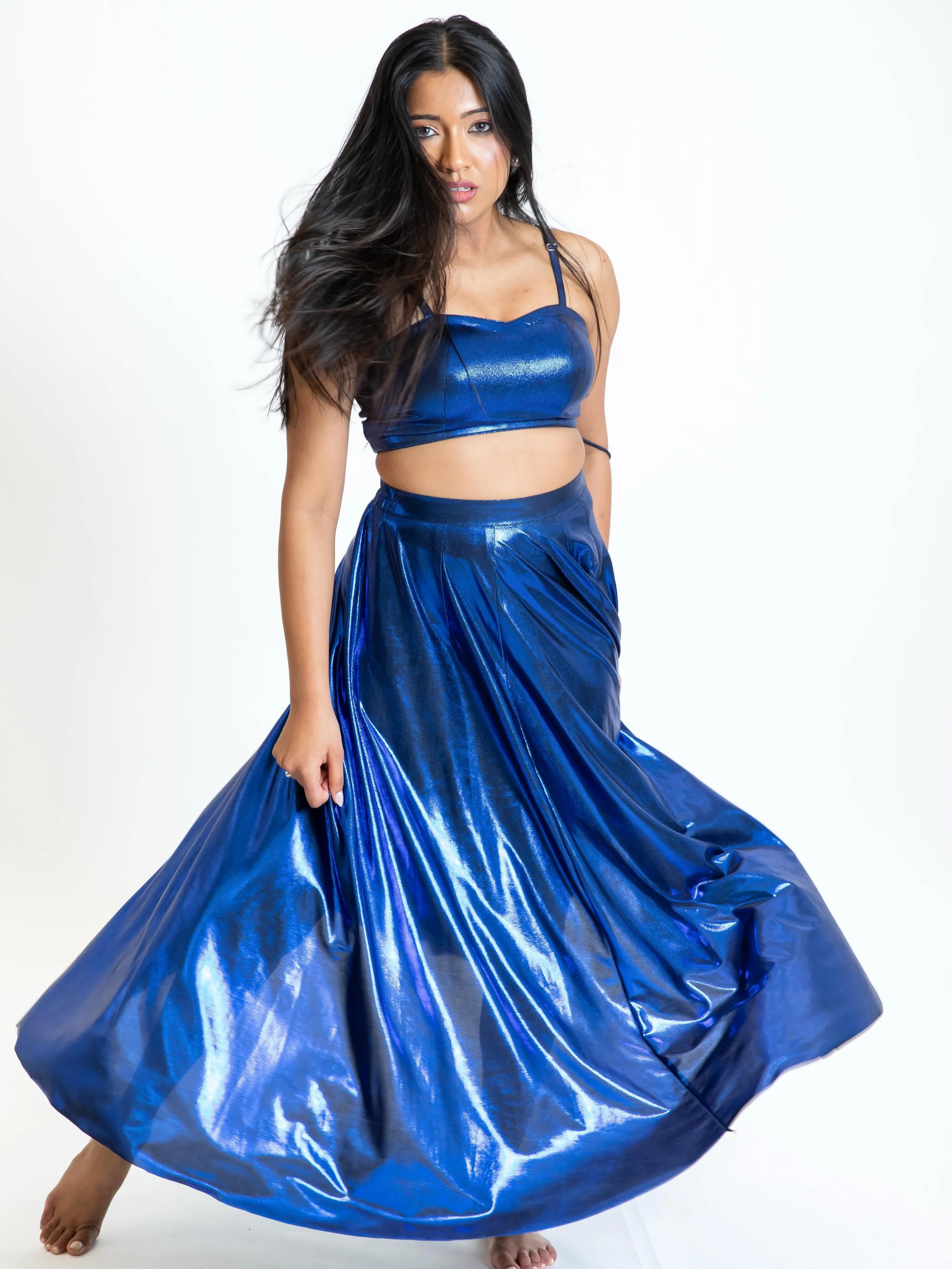 Electric blue, endless movement 💙✨
Meet the Neelam Set &mdash; a striking two-piece crafted in luminous lycra that catches the light with every step, spin, and beat. Featuring a flattering crop top with a playful back tie-up detail and a flowy flare