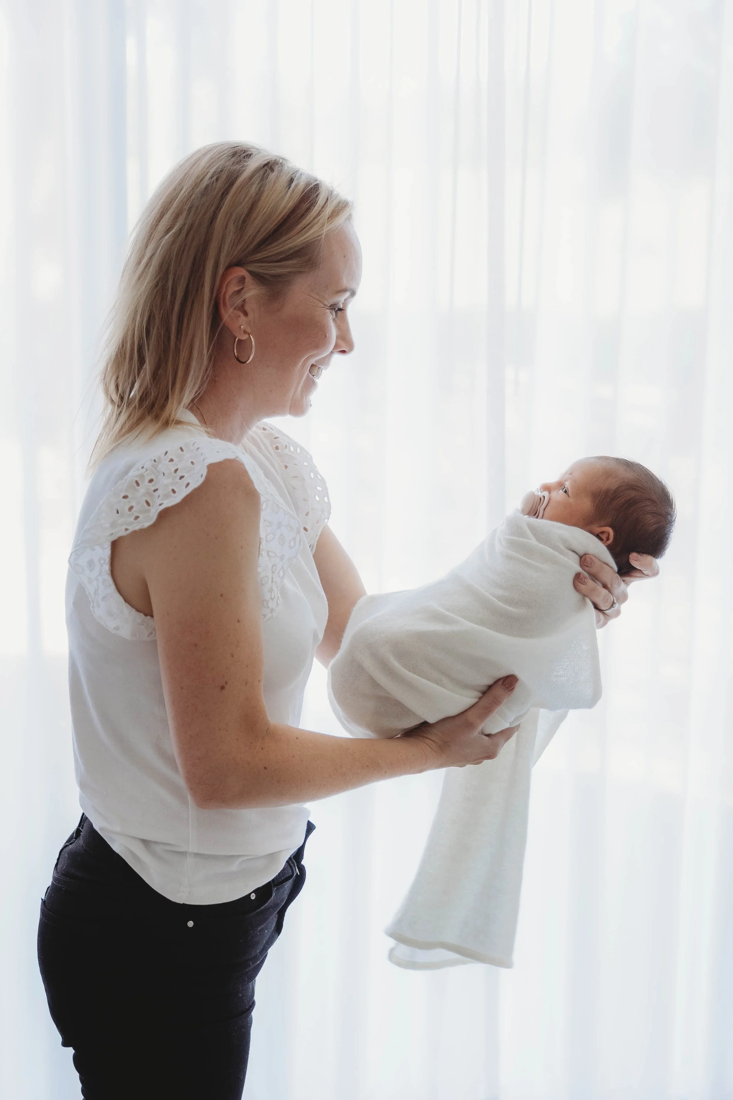 Newborn baby photo with Sue Beaumont Photography holding the precious baby safely
