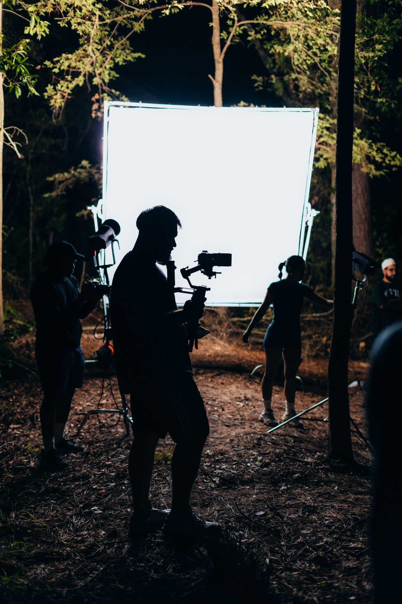 Camera and lighting crew silhouetted on the Resident Evil set.