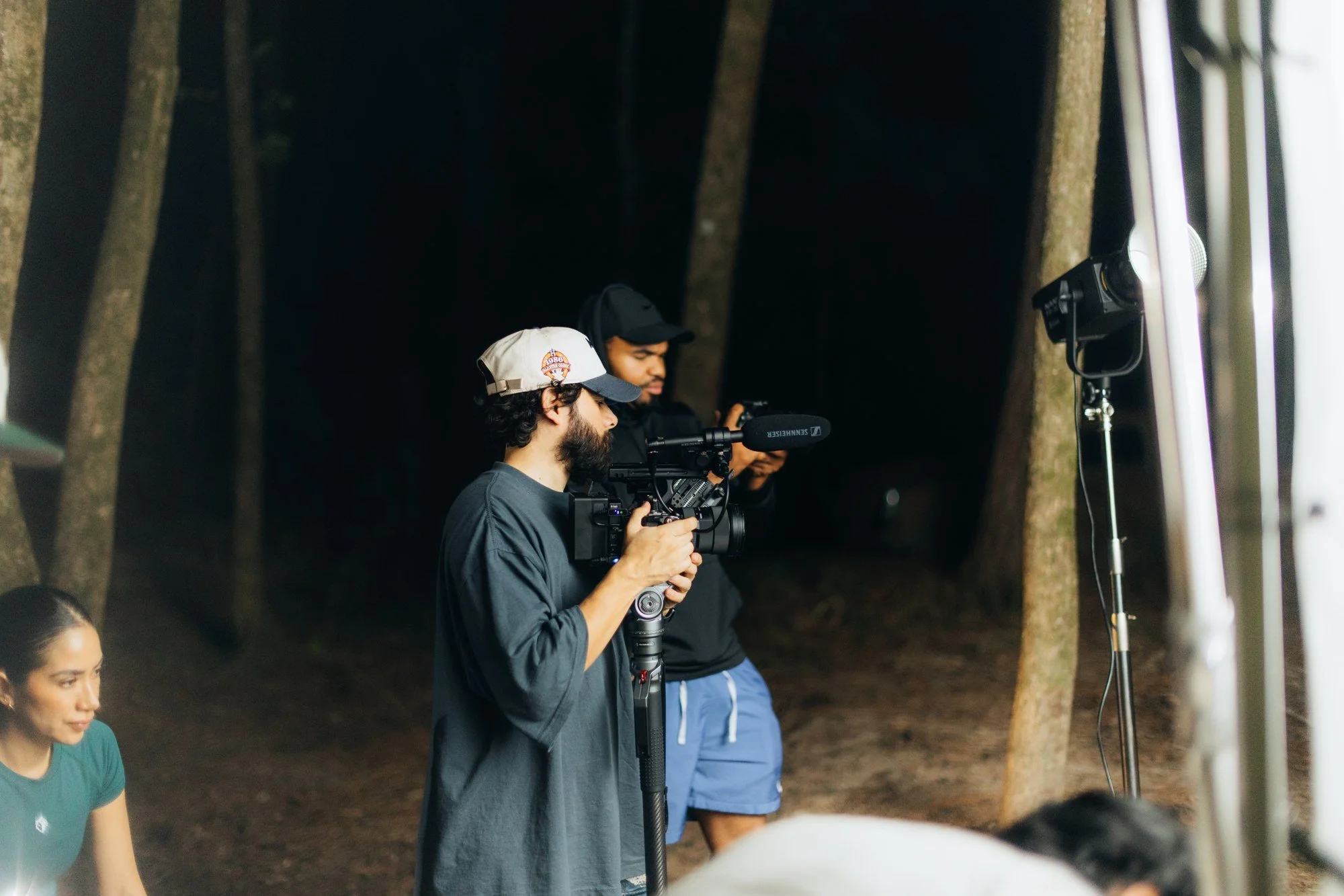The camera team preparing a shot beside the lighting setup.