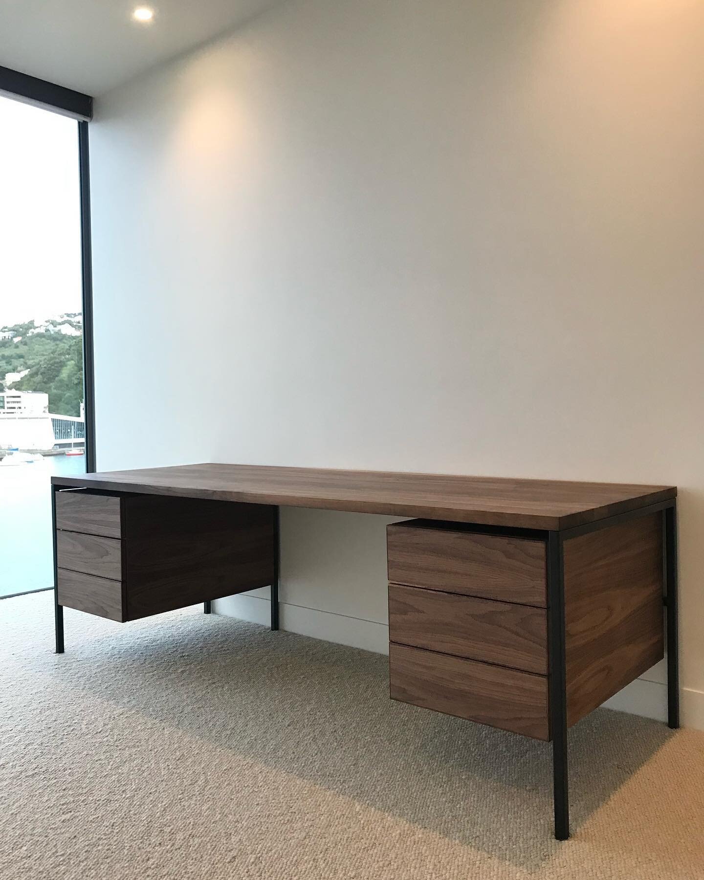 Some recently completed joinery work. This is a home office desk created for some wonderful clients. Made from solid walnut on a square profile extruded steel frame, powder coated matte black. The drawers are hung from the steel frame and appear to f