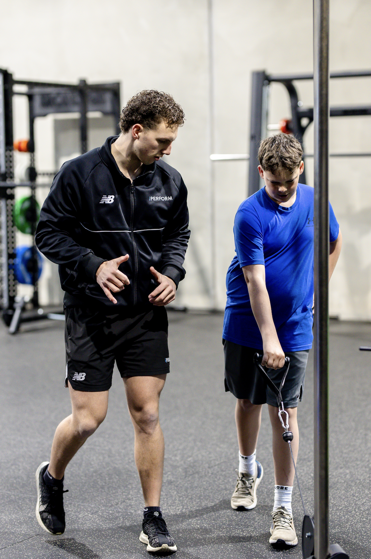 youth athlete with S&C coach cable machine exercise