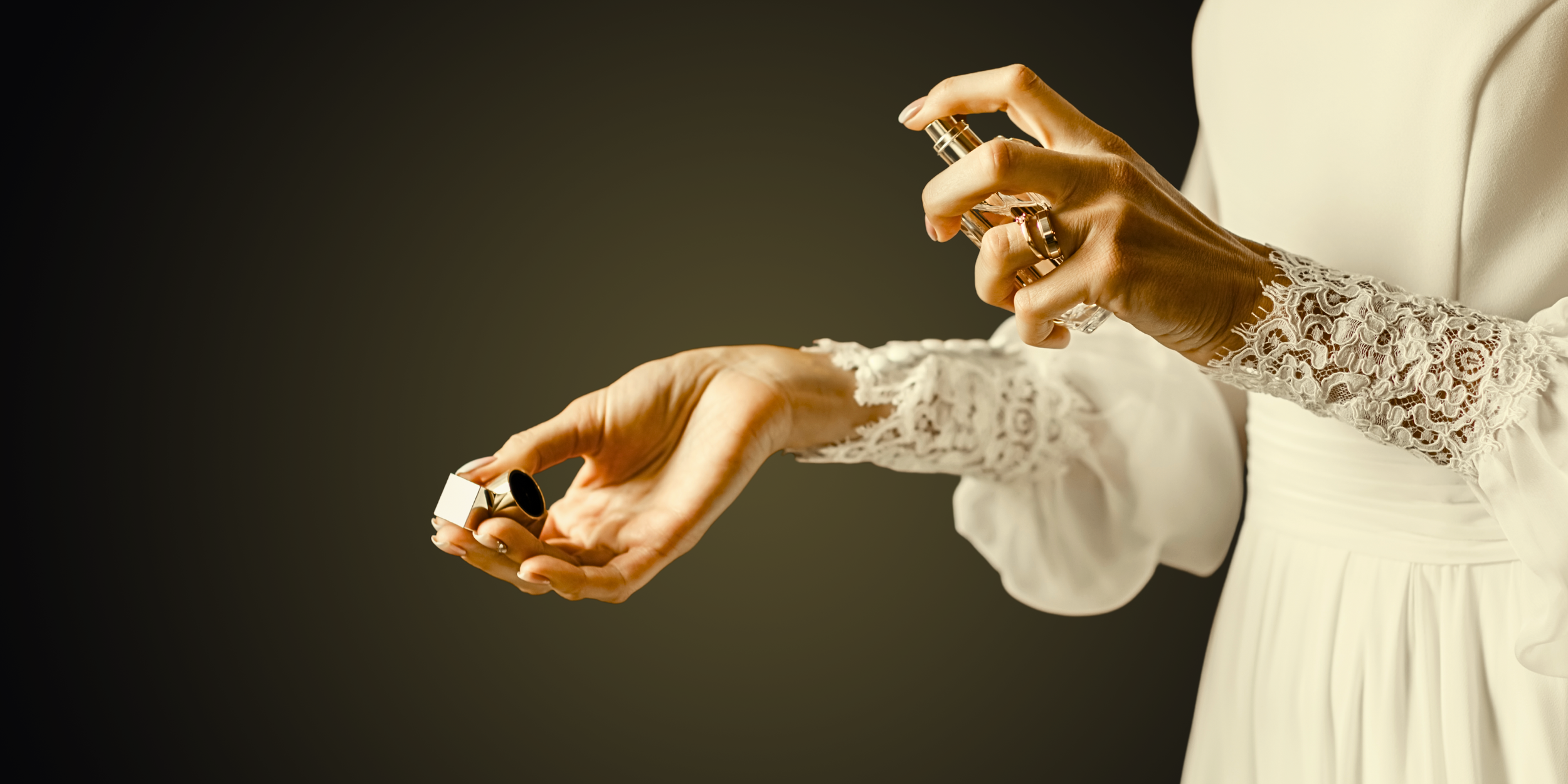 A woman spraying a perfume on her wrist