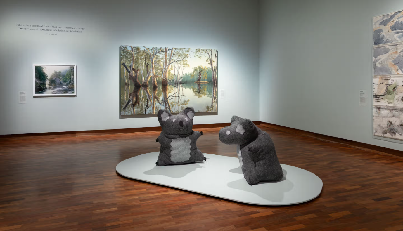 Gallery with two large koala soft sculptures and a big painting of eucalyptus trees