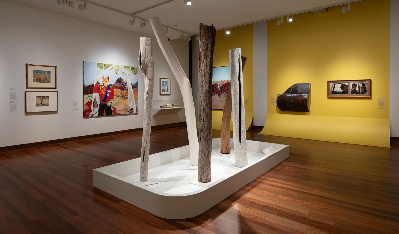 a gallery exhibition with yellow walls
