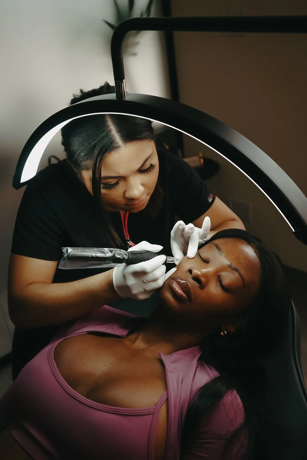 A practitioner carrying out a facial skin treatment in the clinic