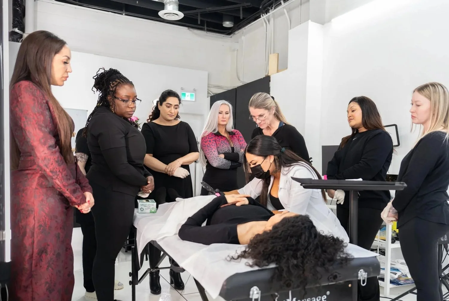 A Wholesome Empire training group observing a treatment demonstration