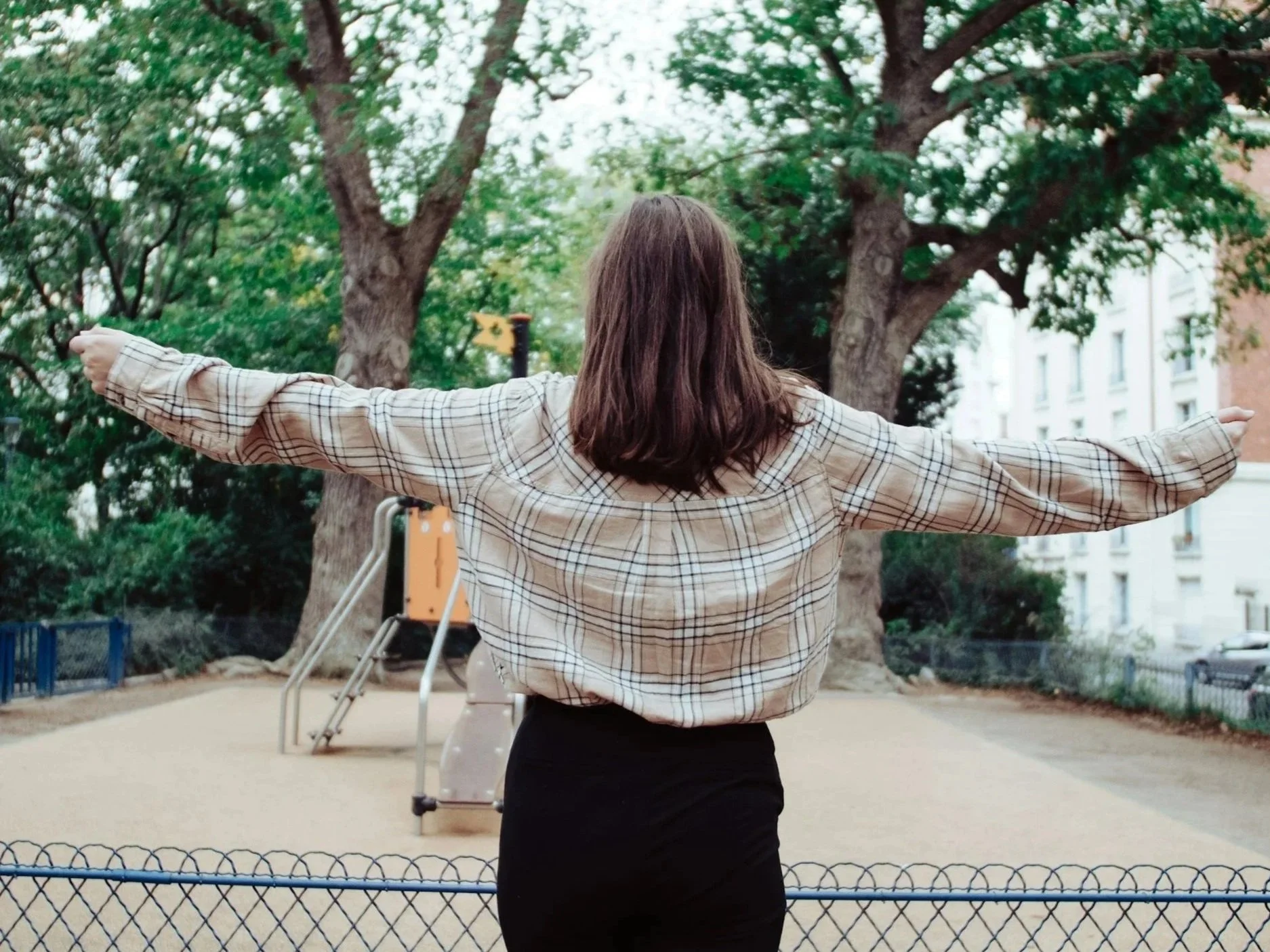 A happy woman holding her arms out wide, capturing the feeling of freedom and peace that comes with setting healthy boundaries.