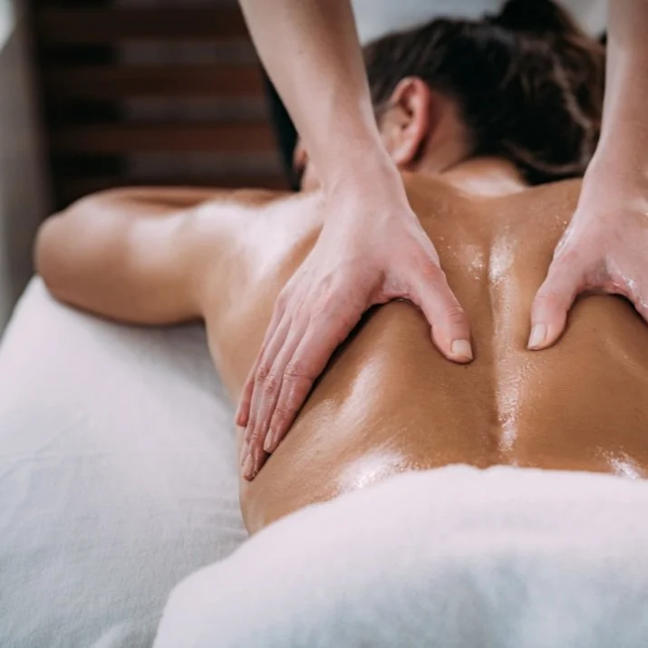 Woman laying down and receiving a back facial