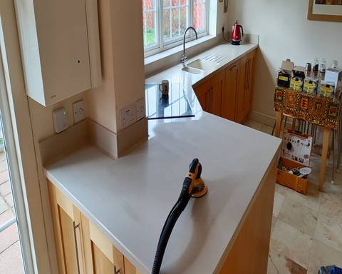 Professional dustless sanding of a dull Corian kitchen worktop during a restoration project in Shere near Guildford.