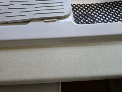 The swollen worktop sink edge has been completely restored and is invisible