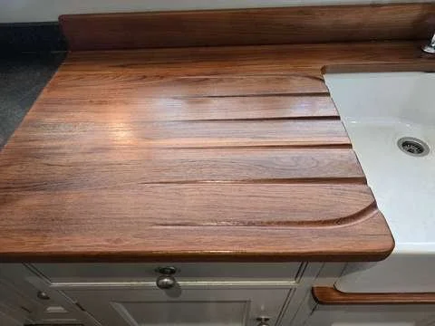 The exact same wooden kitchen worktop fully restored, with the hot pan burn mark completely removed and sealed with protective hardwax oil.