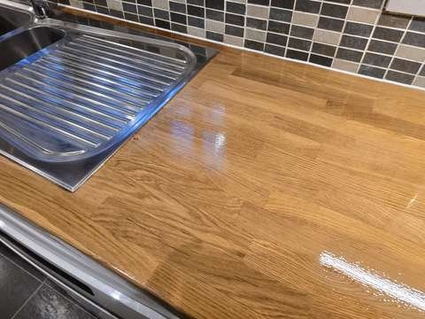 A freshly sealed oak stave kitchen worktop showing a smooth, protective hardwax oil finish with no visible heat rings or candle burns.