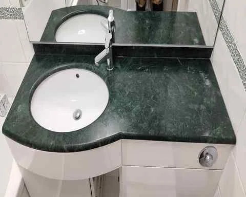 A stone worktop that has water damage repaired and is polished back to gloss