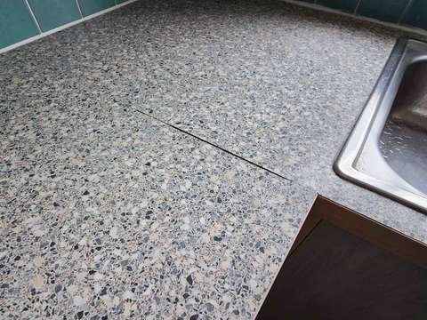 A blown and expanded joint on granite effect laminate worktop