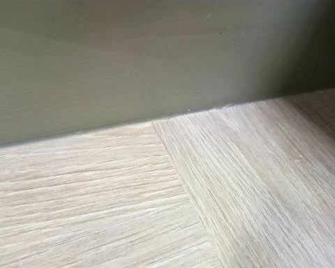 The same light oak laminate worktop joint fully restored with a seamless pattern-matched finish in Guildford.