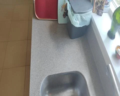 Flawlessly polished grey solid surface kitchen counter after a professional scratch removal process in Guildford.